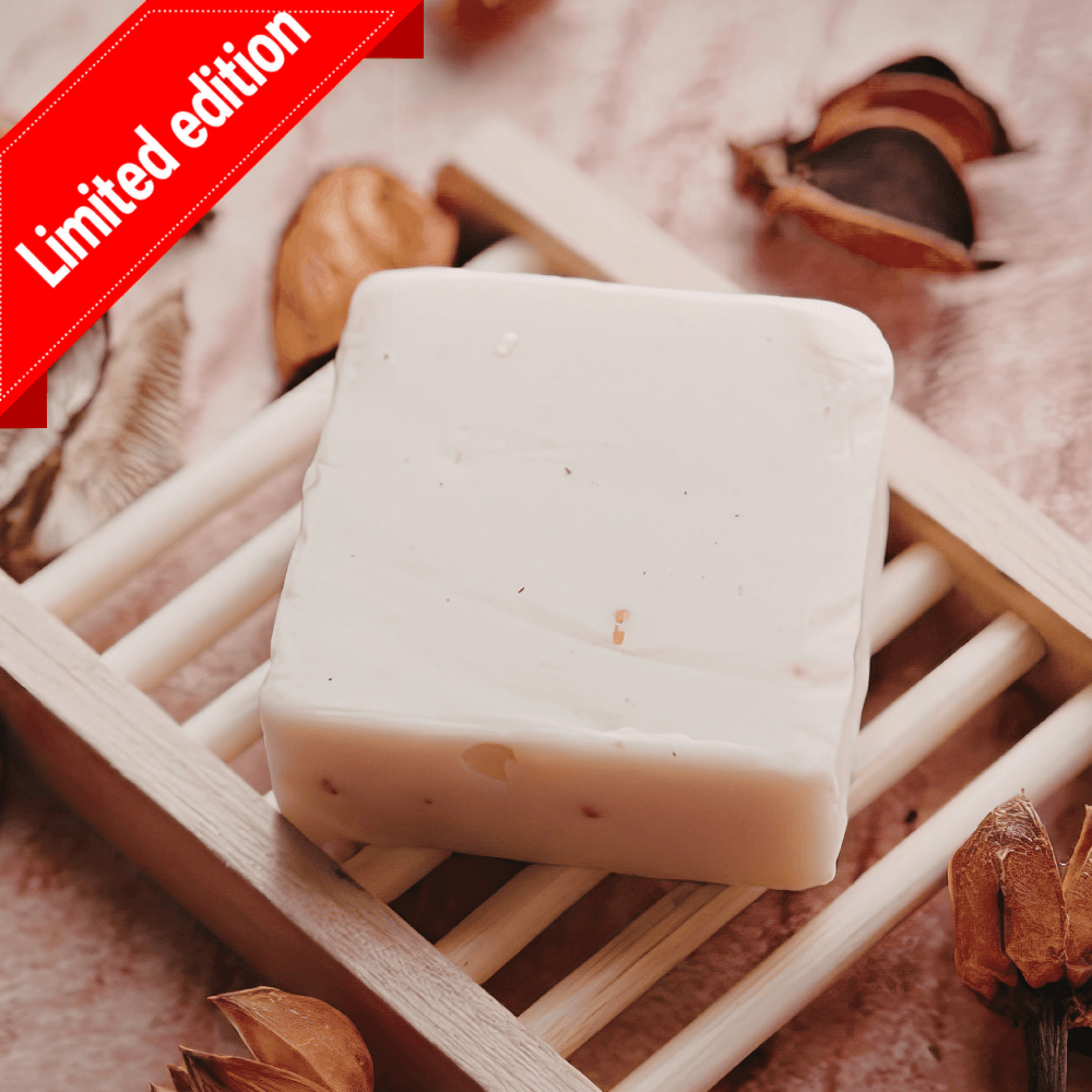 Limited-edition red cypress kefir soap: a white bar on a wooden soap dish among dried seed pods