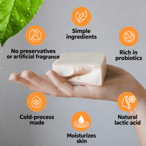 Hand holding a bar of kefir cold-process soap, with six features: simple ingredients, no preservatives, probiotics, moisturising